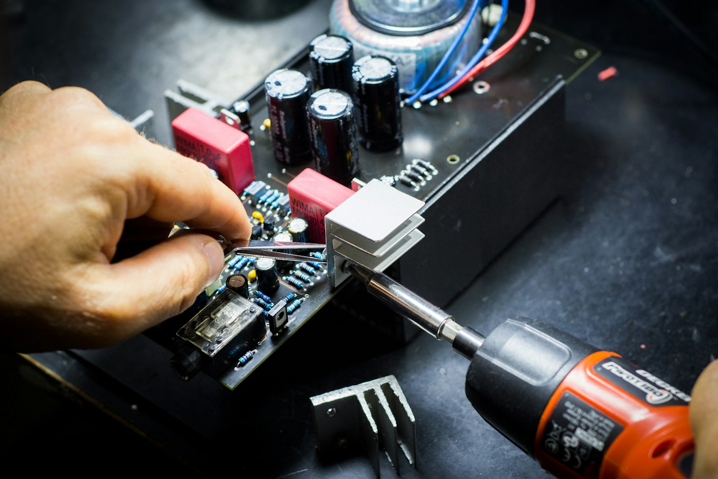 Technician installing hardware with a screwdriver